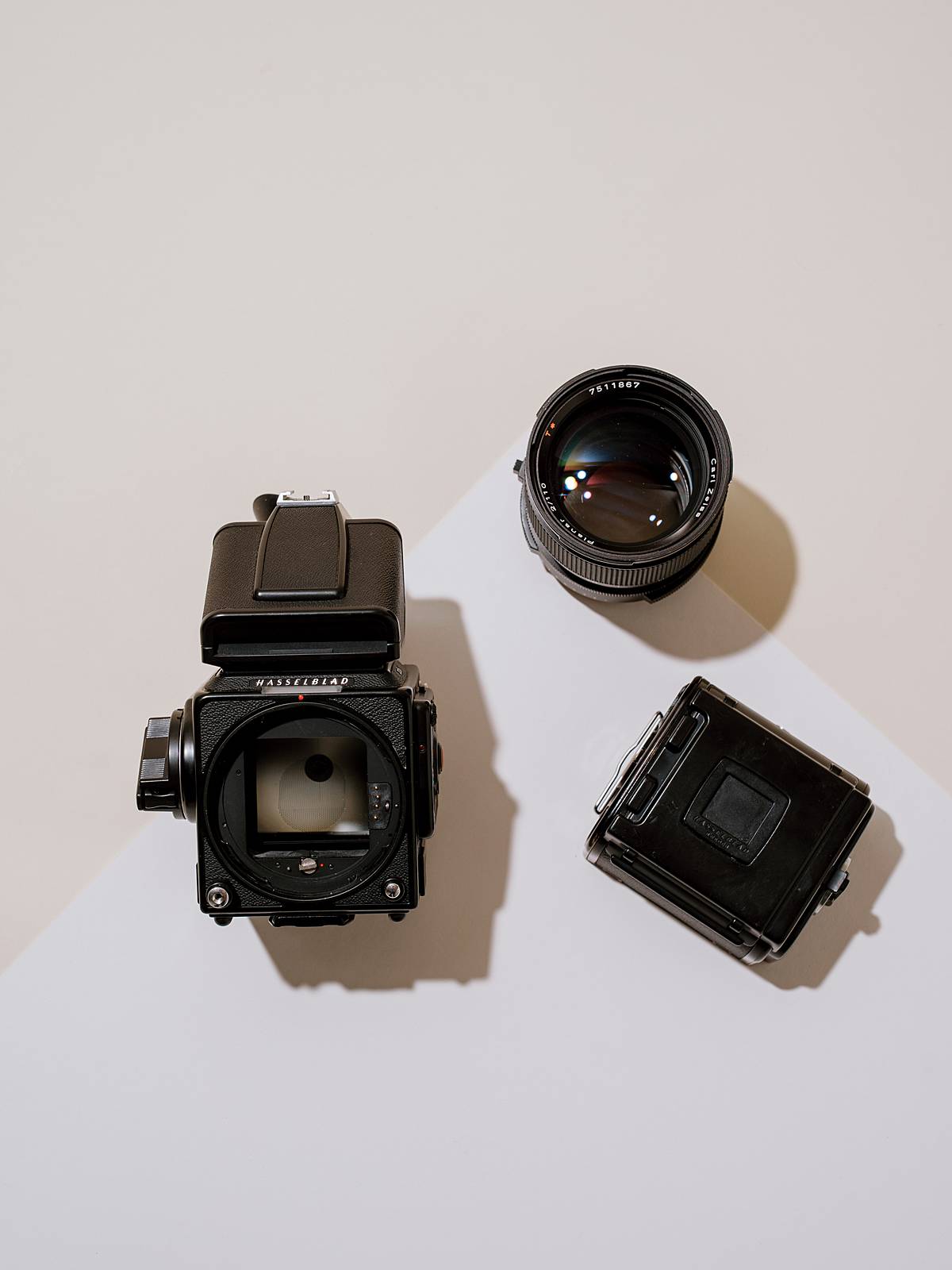 hasselblad 202fa medium format camera system in pieces in studio on tan seamless